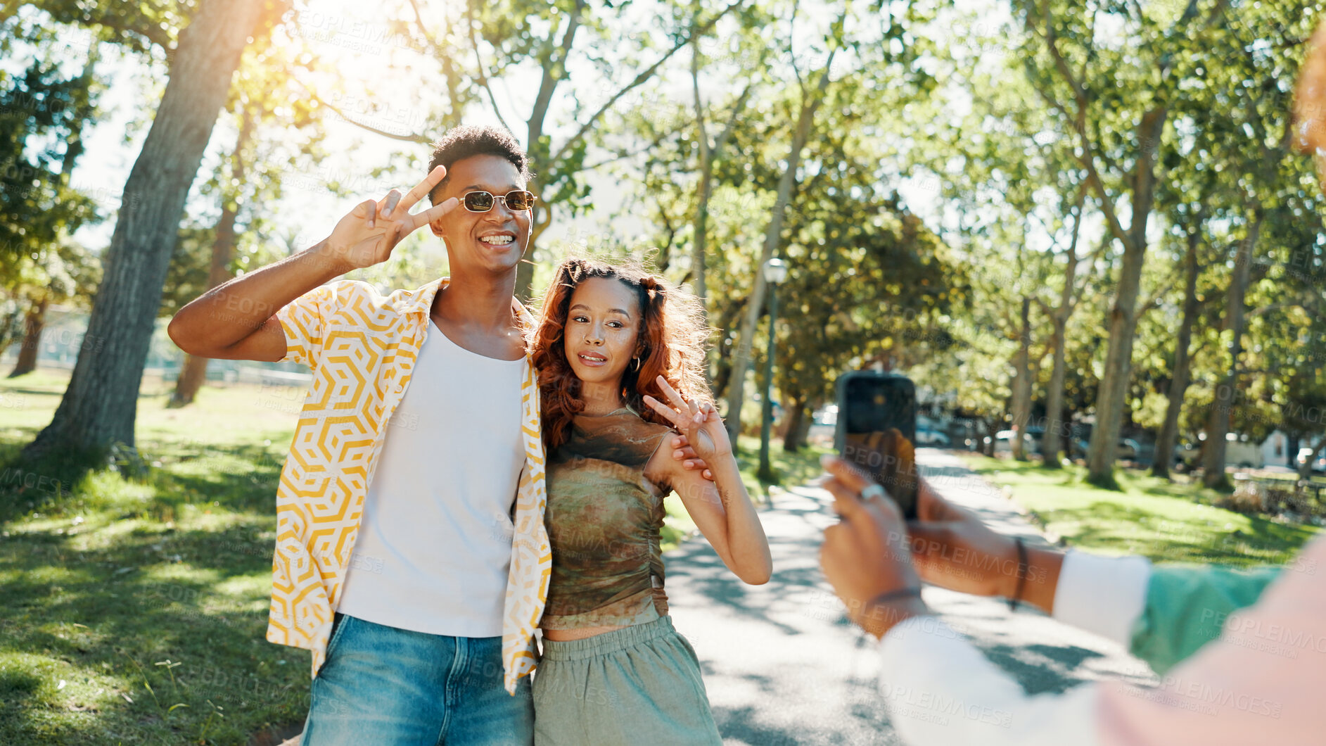 Buy stock photo Happy, peace sign and couple in park for photograph together for love, bonding or relationship in summer. Fashion, social media influencer or man with woman in nature for picture, vacation or holiday
