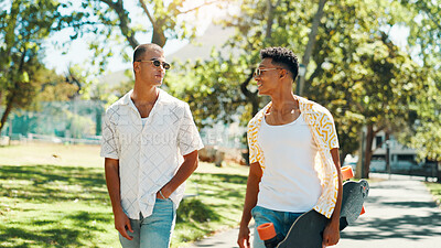 Buy stock photo Walking, friends and men with skateboard, fashion and bonding with conversation in city or outdoor. Trendy, skateboarder and people with sunglasses on road, smile and talking on break and travel