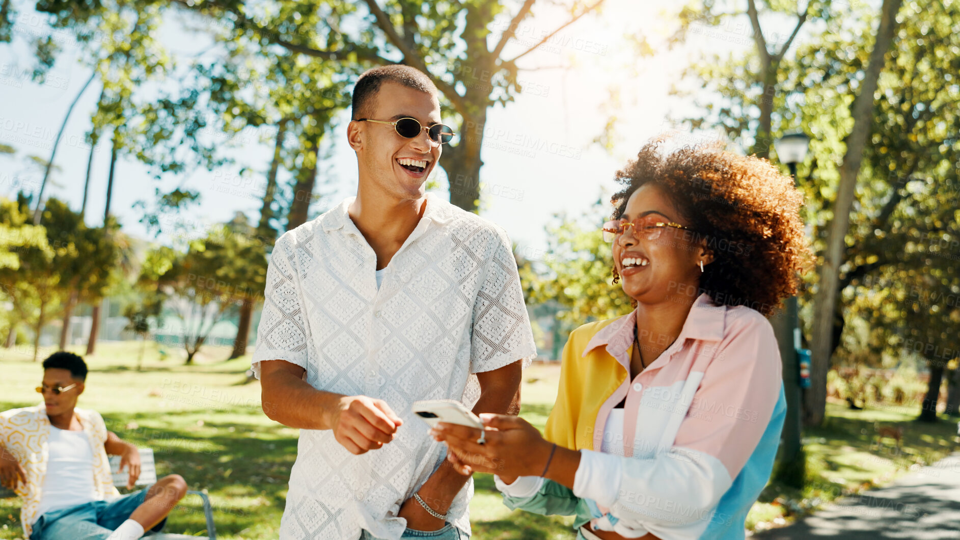 Buy stock photo Phone, couple and laugh at park for social media post, online blog and funny meme. Mobile, man and woman outdoor in interracial relationship together on date for internet, communication or comedy app