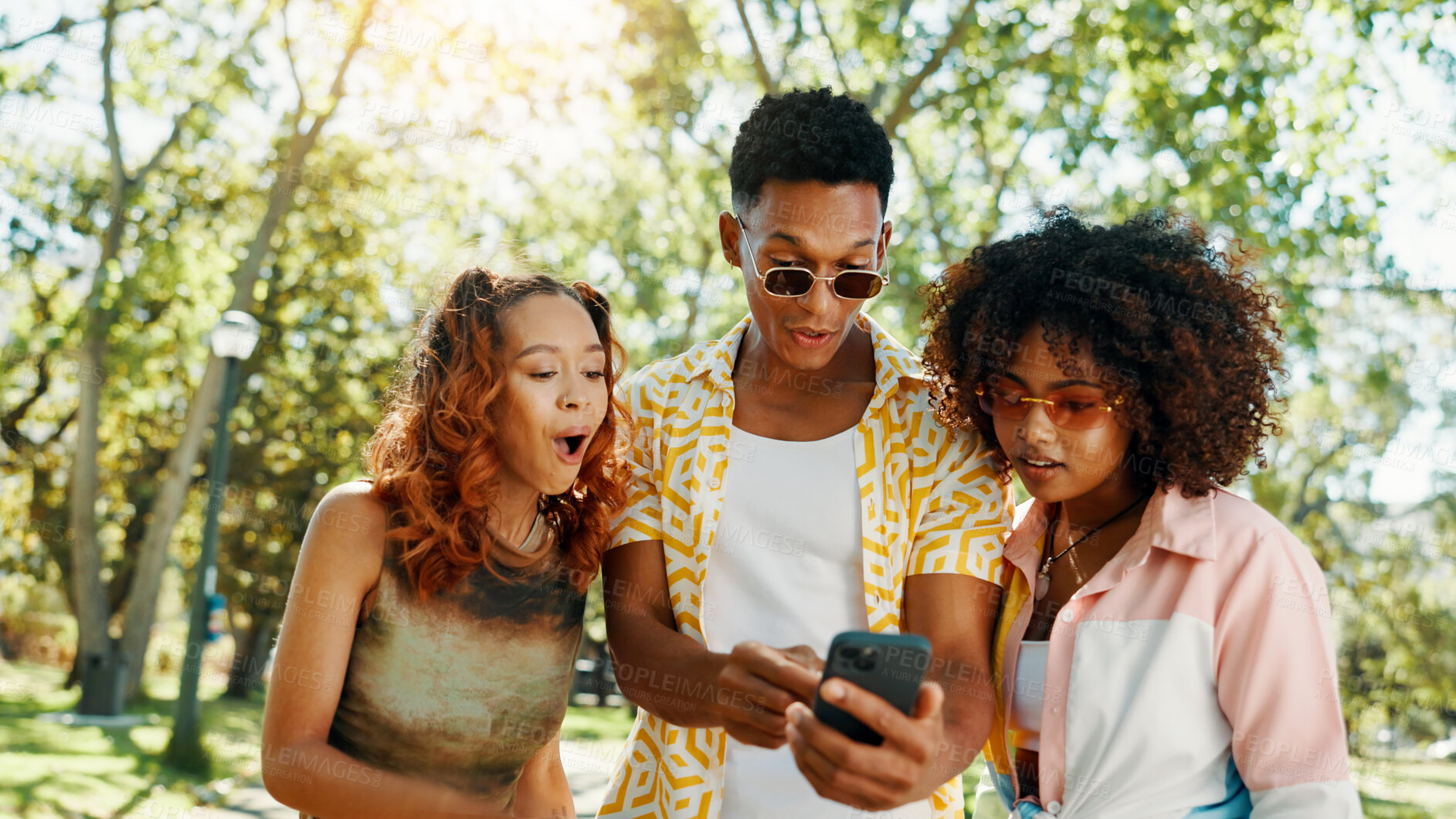 Buy stock photo Friends, phone and surprise with social media at park for online update, gossip post and drama news. Gen z people, shocked and smartphone with internet information, announcement or text notification