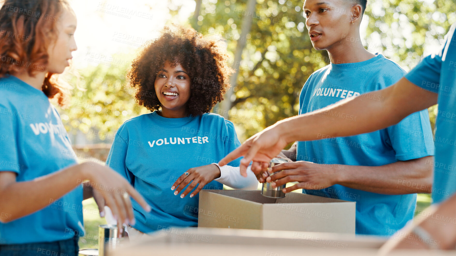 Buy stock photo People, volunteer and boxes of donation at park for giving food, packing supplies and community aid. Staff, helping and sorting products for charity outreach, teamwork and distribution of NGO welfare