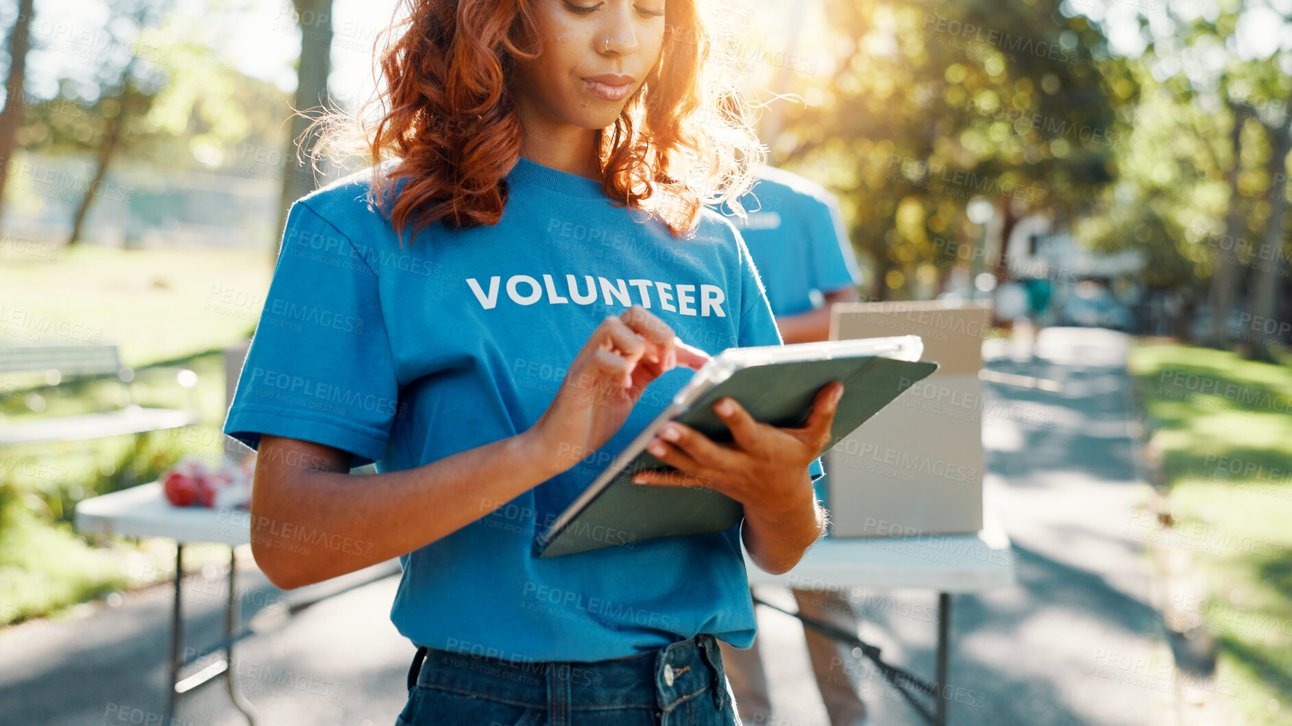 Buy stock photo Nature, woman and volunteer with tablet for research on food drive donation list for community. Reading, outdoor and female NGO worker with digital technology in park for nonprofit or charity event.