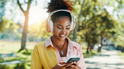 Buy stock photo Park, woman and smile with smartphone for music, audio track and check location on vacation outdoor. Nature, African female person and tourist with mobile for travel application, happy and headphones