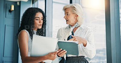 Buy stock photo Women, discussion and documents with tablet in office, finance and feedback with report in hallway. Business people, talk and app with paperwork for review, listen and advice at investment agency