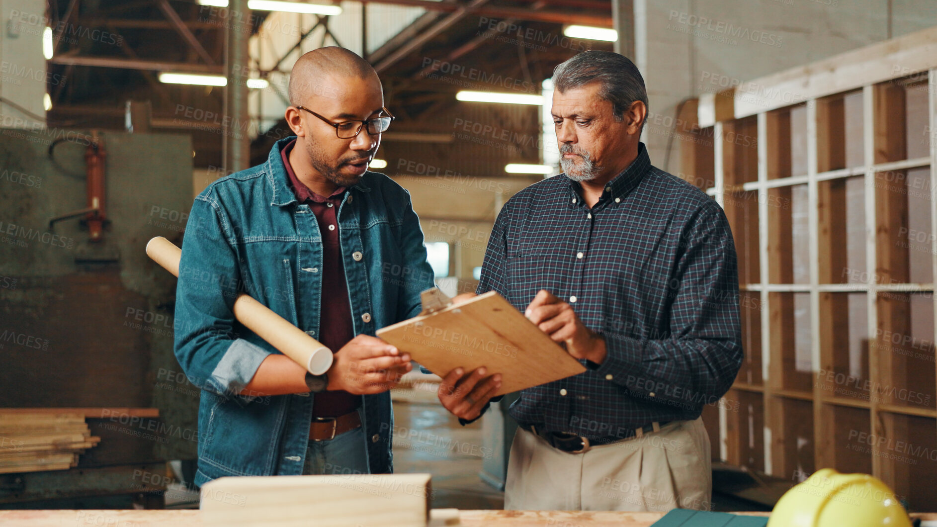 Buy stock photo Carpentry, meeting and men in workshop with clipboard for furniture, restoration and lumber manufacturing. Construction, factory and carpenters planning with planks, timber and board for renovation