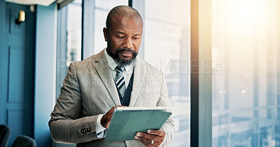 Buy stock photo Tablet, research and mature businessman by window in office for company budget plan with dividend. Digital technology, email and male financial manager with investment proposal for profit or revenue.