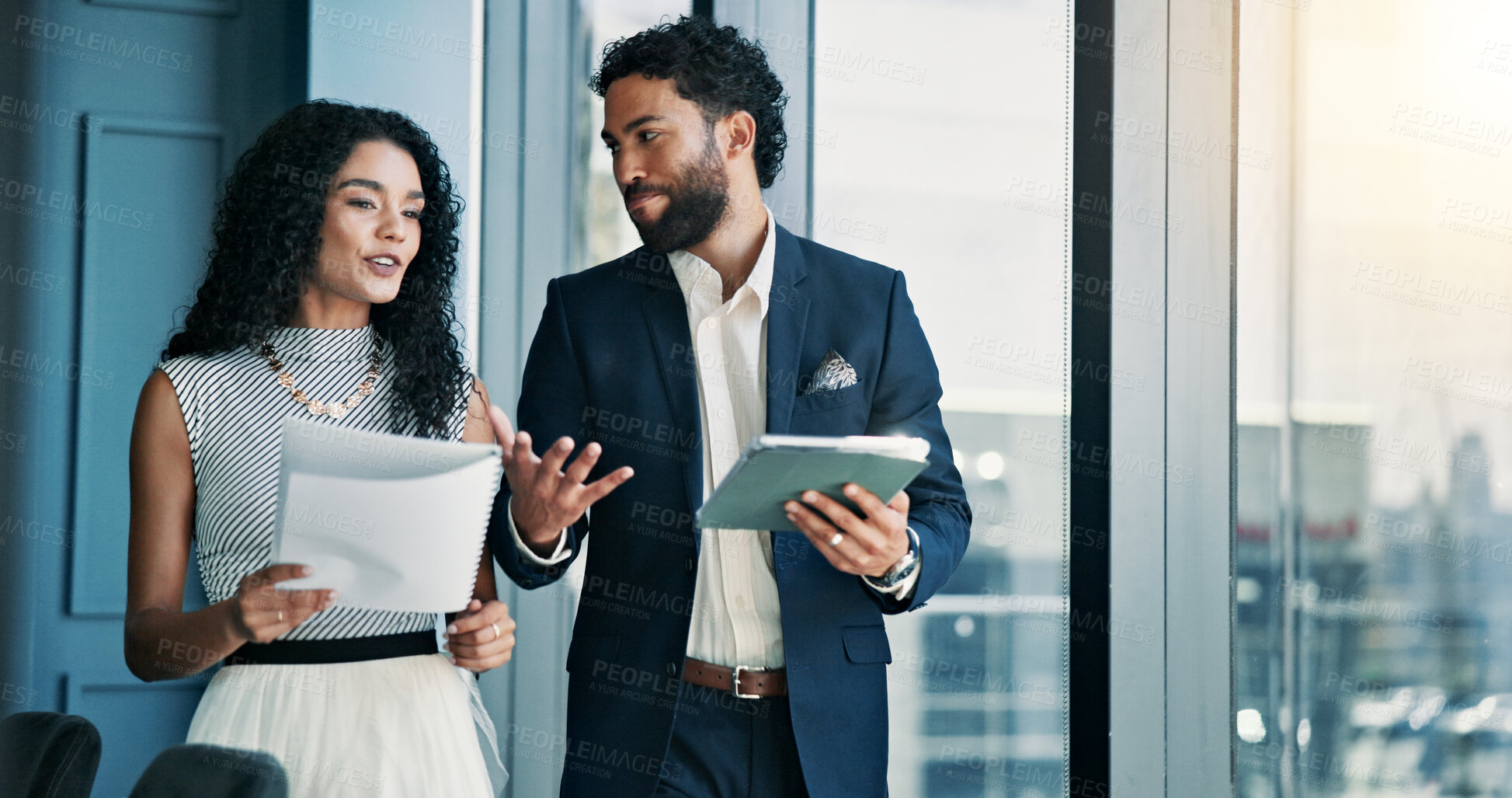 Buy stock photo Woman, man and discussion with tablet in office, finance or feedback for report in hallway. Business people, talk and happy for results, document or review with stock performance at investment agency