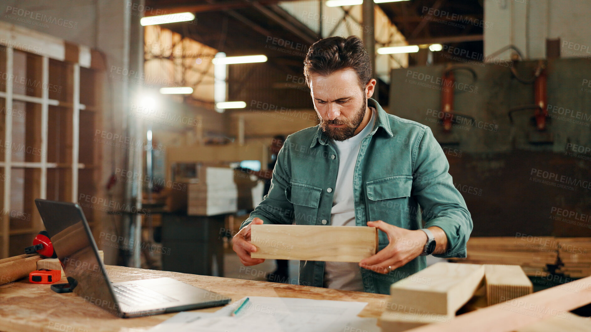 Buy stock photo Carpenter, laptop and planning with wood to measure for construction, furniture or project. Woodworker, person and plank with blueprint in creative carpentry workshop for manufacturing, art and craft