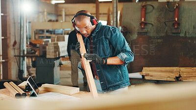 Buy stock photo Carpenter, check or sanding wood for construction, furniture or renovation project planning. Woodworker, black man and plank with tablet in carpentry workshop for manufacturing, art or craft tutorial