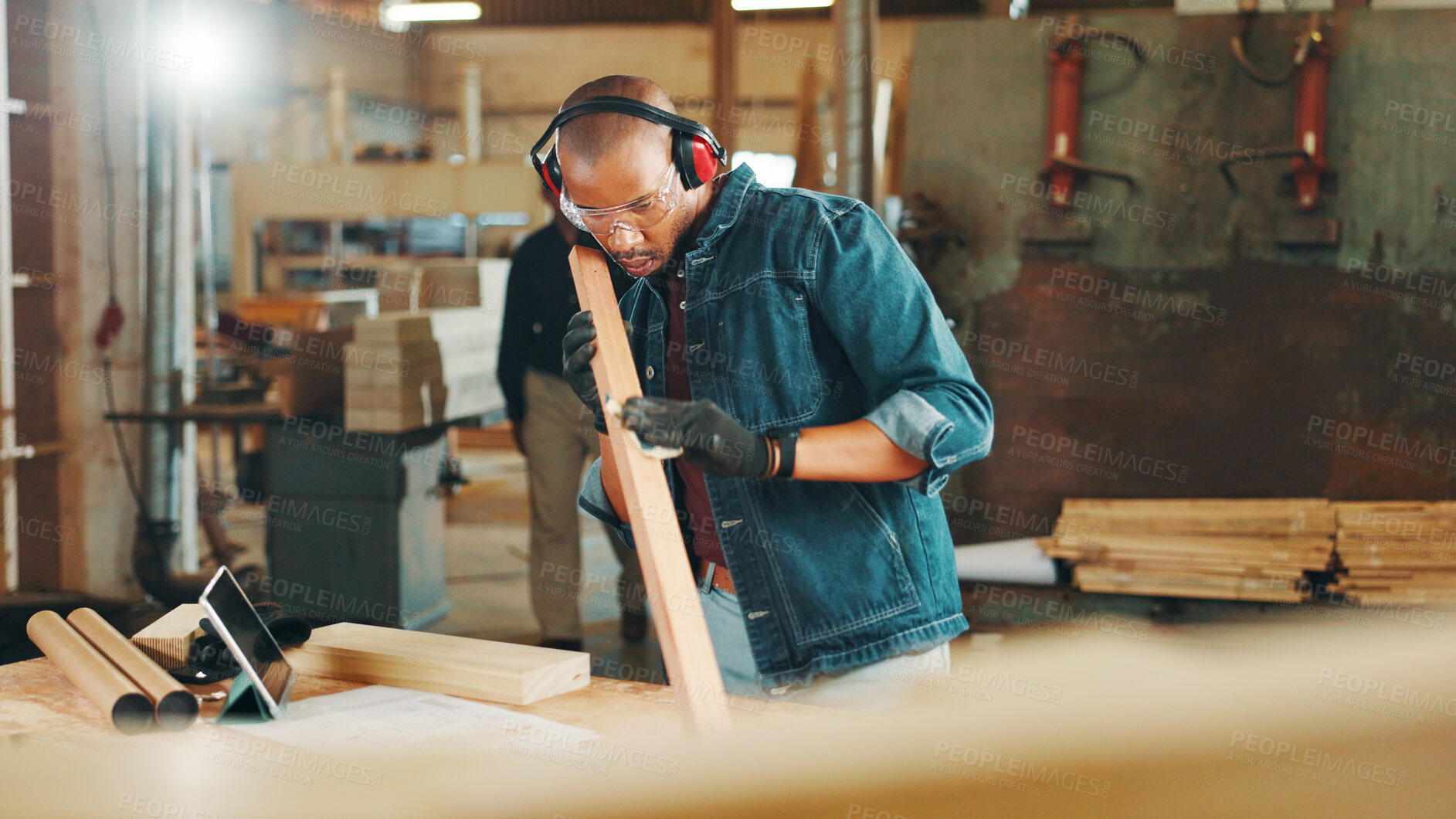 Buy stock photo Carpenter, check or sanding wood for construction, furniture or renovation project planning. Woodworker, black man and plank with tablet in carpentry workshop for manufacturing, art or craft tutorial
