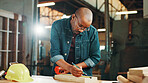 Measuring tape, wood and writing with carpenter black man in workshop for manufacturing or production. Carpentry, construction and planning with professional contractor at work for renovation