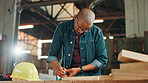 Measuring tape, woodwork and writing with carpenter man in workshop for manufacturing or production. Carpentry, construction and pencil mark with professional contractor at work for renovation