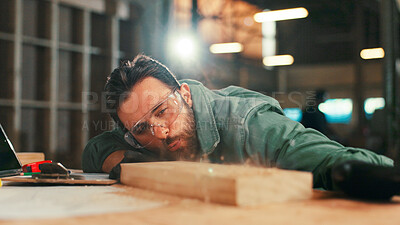 Buy stock photo Carpentry, workshop and man with sawdust on wood for furniture, restoration and lumber production. Construction, factory and carpenter blowing debris for planks, timber and woodworking for renovation