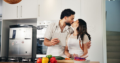 Buy stock photo Tablet, kiss and cooking with couple in kitchen for health, food and online recipe. Love, bonding and nutrition ingredients with man and woman helping at home for meal prep, wellness and lunch menu