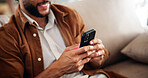 Home, hands and man on sofa, smartphone and texting with social media, internet and connection. Closeup, apartment and person on couch, cellphone and communication with digital app, email and message