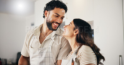 Buy stock photo Home, cooking and couple in kitchen, funny and bonding together with apron, romance and marriage. People, relationship and man with woman, happiness and healthy meal with smile, lunch and love