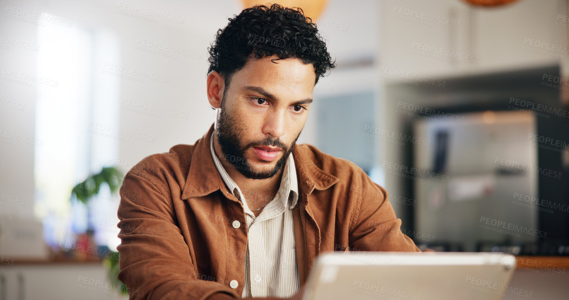 Buy stock photo Reading, tablet and remote work with man in kitchen for research, blog writer and news post. Entrepreneur, freelancer and online feedback with person at home for media update, startup and planning