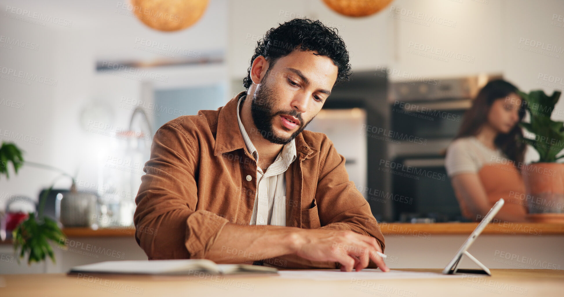 Buy stock photo Tablet, freelancer and man in home with paper for research, reading and content writer review blog. Digital technology, serious and remote work with notebook for copywriting, online or social media