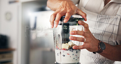 Buy stock photo Hands, home and man in kitchen, blender and smoothie with diet plan, fruits and milkshake process. Closeup, gut health and person with protein, machine and nutrition drink with organic ingredients