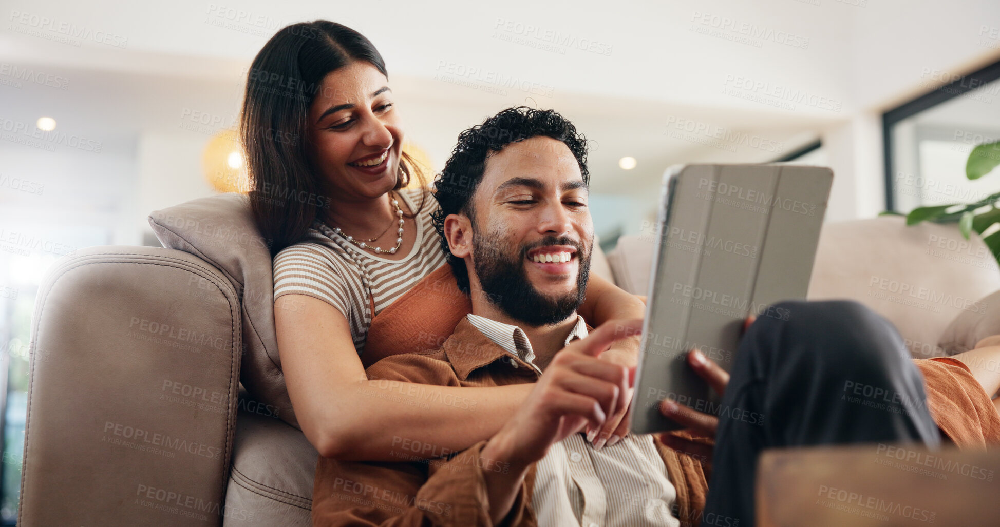 Buy stock photo Couple, relax and smile with tablet on sofa for internet browsing, social media post and bonding together. People, happy and digital app in house for web scrolling, streaming service and connection