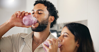 Buy stock photo Drink, smoothie and morning with couple in kitchen for detox glass, breakfast and gut health. Organic fruit, nutrition and wellness with man and woman at home for juice, protein shake and vitamins