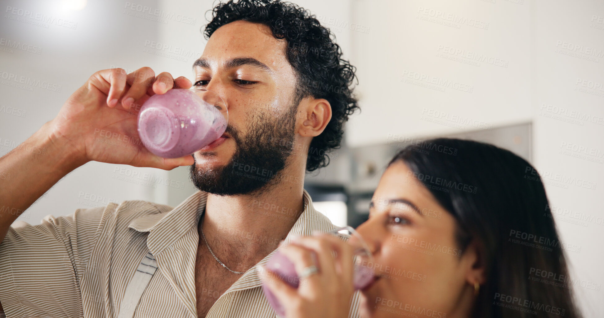 Buy stock photo Drink, smoothie and morning with couple in kitchen for detox glass, breakfast and gut health. Organic fruit, nutrition and wellness with man and woman at home for juice, protein shake and vitamins