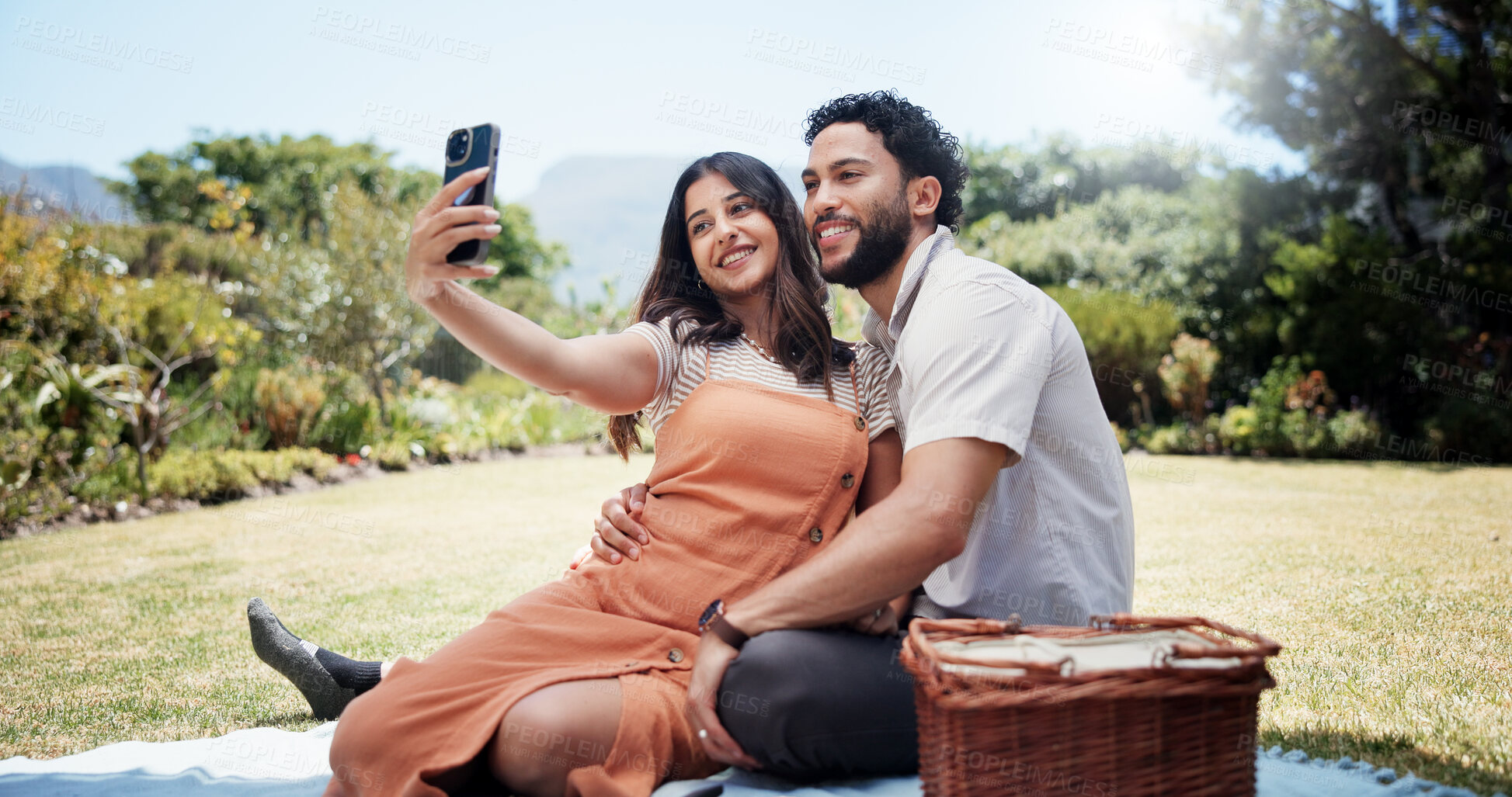 Buy stock photo Couple, happy and selfie in nature for picnic, love and social media update on anniversary date. Man, woman and relax in park for photography, bonding and making memories on weekend in marriage