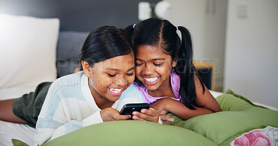 Buy stock photo Smile, kids and relax with phone in bedroom on social media, watching cartoon and streaming service. Happy, girls and mobile on internet with funny videos, reading ebook and app subscription at house