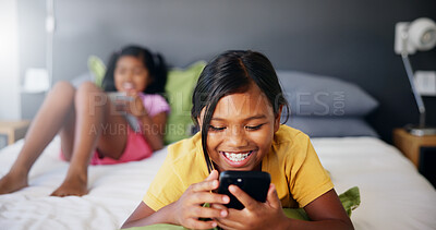 Buy stock photo Happy, child and relax with phone in bedroom on social media, watching cartoon and streaming service. Smile, girl and mobile on internet with funny videos, reading ebook and app subscription at house