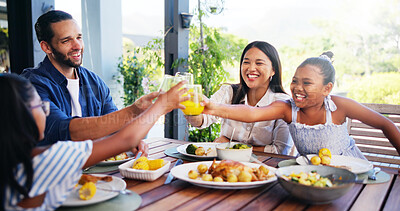 Buy stock photo Happy family, lunch and cheers with juice for celebration at outdoor patio with love, care and bonding together. Mom, dad and kids toast with drink glass for food or healthy meal with parents at home