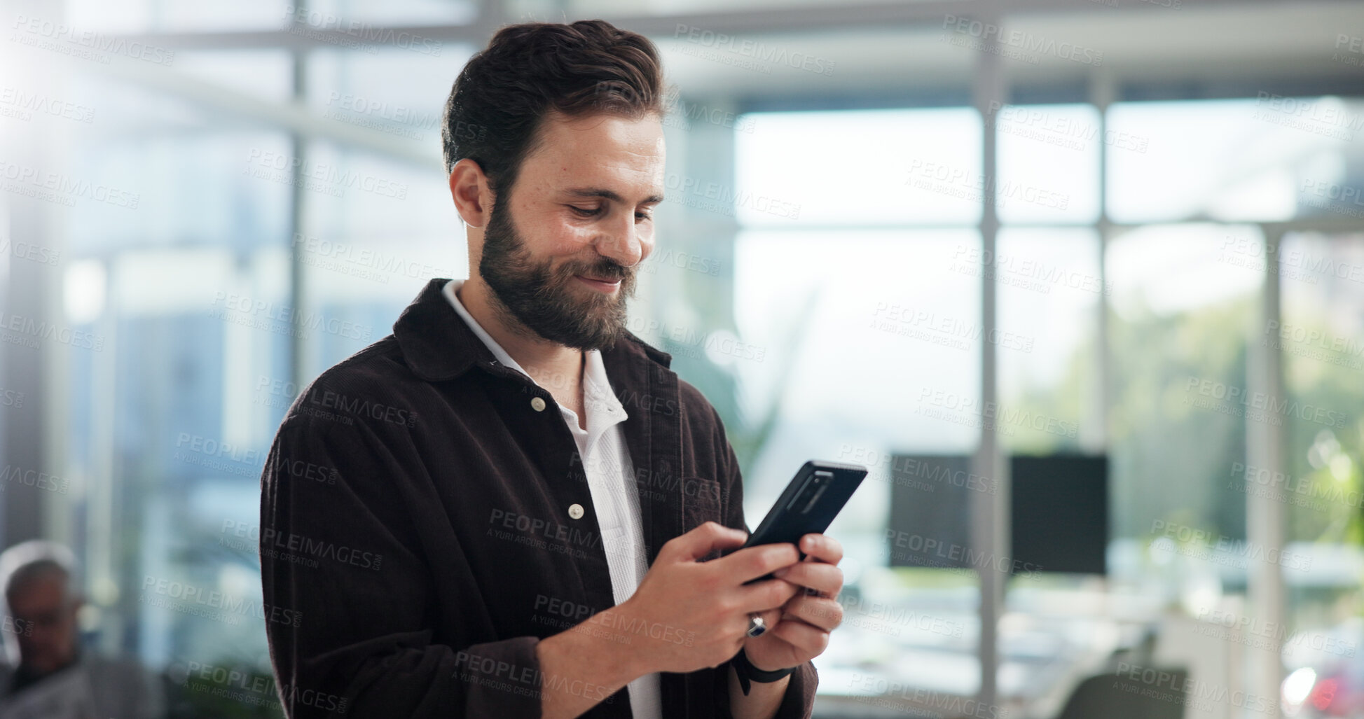 Buy stock photo Smile, creative and business man with mobile in office for networking, typing text or social media marketer online. Phone, startup and worker reading email, campaign and brand promotion on platform