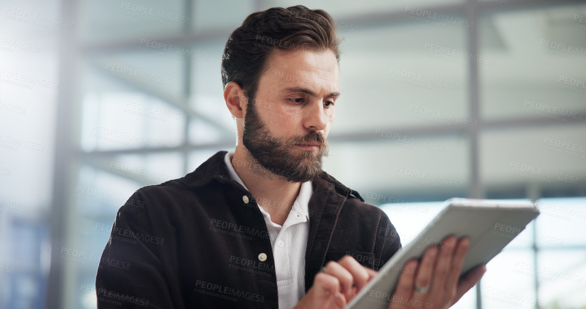 Buy stock photo Scroll, creative and business man with tablet in office for networking or social media marketer online. Technology, startup and serious worker reading email, campaign and brand promotion on platform