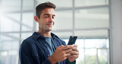 Buy stock photo Smile, creative and business man with smartphone in office for networking, typing or social media marketer online. Mobile, startup and worker reading email, campaign and brand promotion on platform