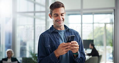 Buy stock photo Typing, creative and business man with phone in office for networking, text message or brand specialist online. Mobile, startup and happy worker reading email, campaign and promotion on social media