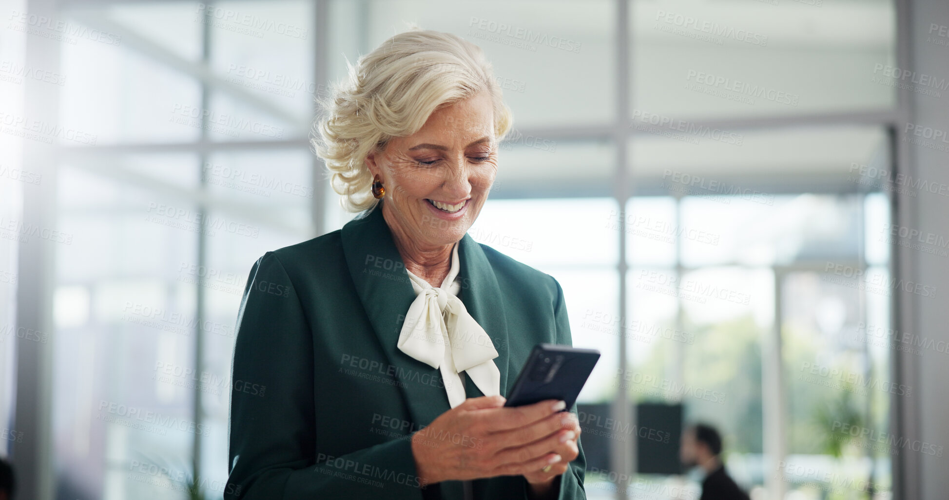 Buy stock photo Smile, mature and business woman with phone in office for networking, investment or reading financial news. Mobile, corporate executive and check email for profit, private equity or venture capital
