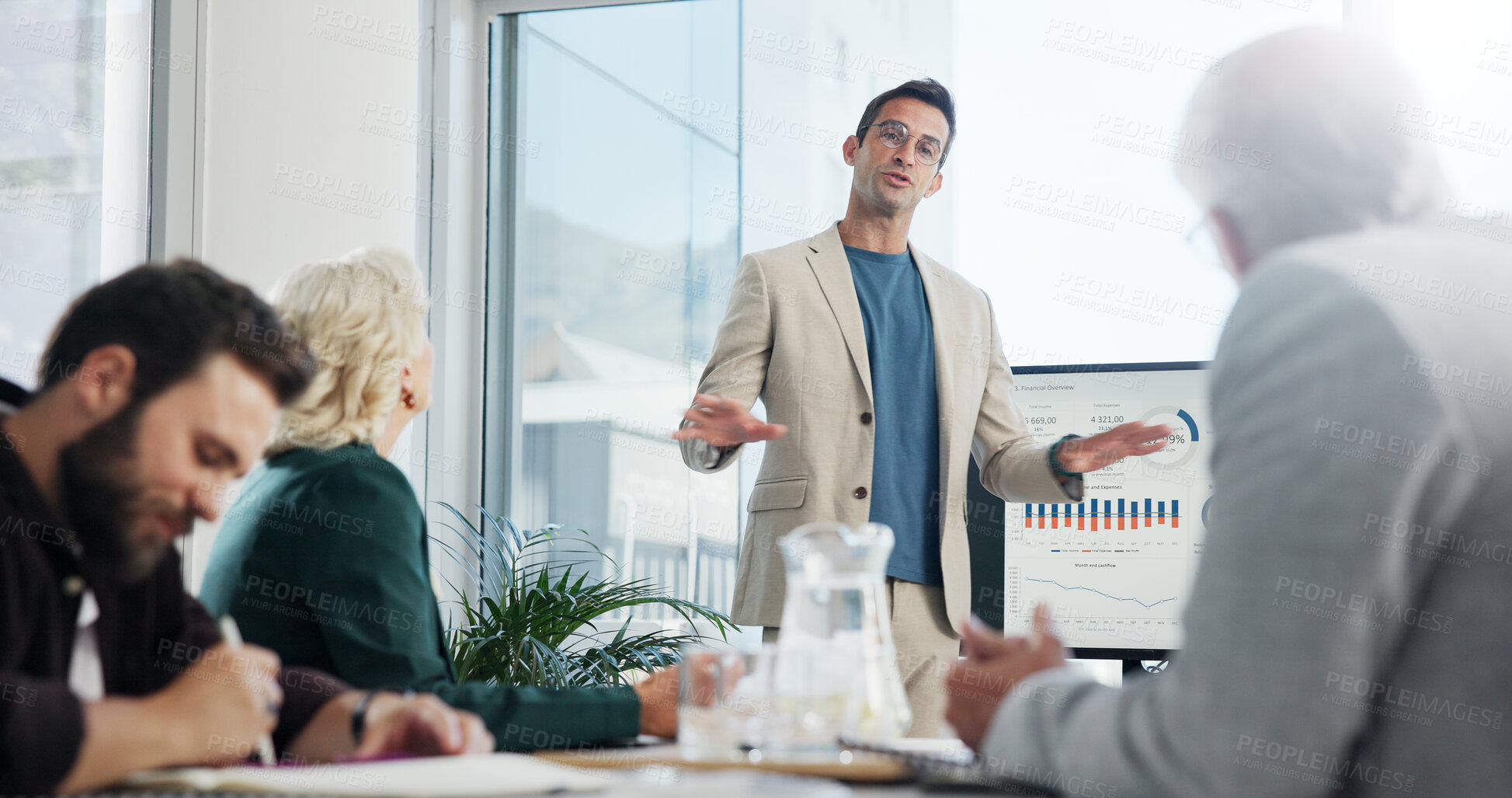 Buy stock photo Presentation, meeting and businessman in office with team for company profit, revenue or dividend. Discussion, professional and financial manager with group of investors for investment planning.