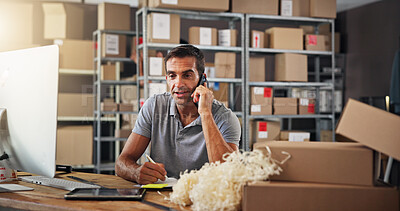 Buy stock photo Computer, logistics and phone call with man in distribution center for communication or update. Boxes, supply chain and writing notes with courier in office for delivery, ecommerce or shipping