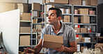 Box, computer and logistics with man in distribution center for checklist, schedule or update. Information, reading and supply chain with employee in office for delivery, ecommerce or shipping