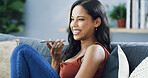 Girl, speakerphone call and happy on sofa, conversation and gossip with mobile networking in living room. Person, woman and smile with smartphone for contact, laughing and chat on couch at apartment