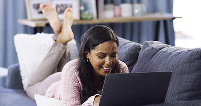 Buy stock photo Woman, laptop and lying on sofa, happy and relax with streaming funny movies in home living room. Girl, smile and computer on couch with search, film or comic show with subscription at apartment