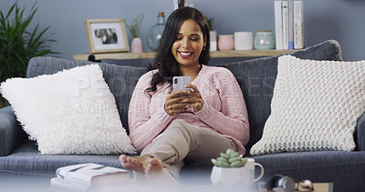 Buy stock photo Woman, phone and texting on sofa, relax and happy on study break, chat and check notification in home. Girl, student and smartphone with contact, mobile app or social network in lounge at apartment