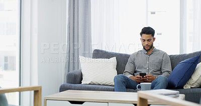 Buy stock photo Man, relax and morning with phone on sofa for online communication, texting or chatting at home. Male person, user or typing with mobile smartphone for connection, network or app on living room couch