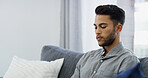 Sad, man and thinking on sofa in home with concern, worry and disappointed for mistake. Mental health, depressed person or thoughtful in living room for regret, bad memory or introspection with space