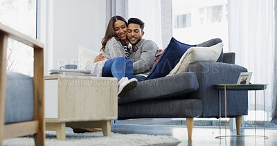 Buy stock photo Bonding, hug and couple with smile, home and chilling in living room with woman, embrace or love. Happy, man and romance with partner in lounge, coffee and comfortable in house, relax or relationship