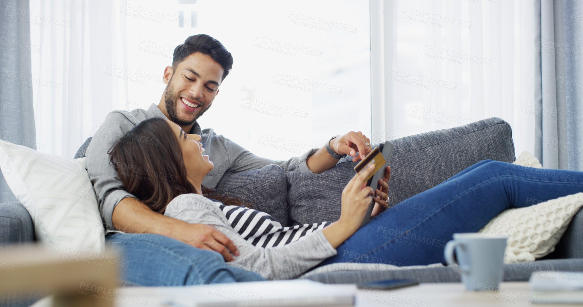Buy stock photo Conversation, credit card and couple on couch, tablet and home with ecommerce, transactions and fintech. Banking, man and woman on sofa, online shopping and payment for mortgage, talking and savings