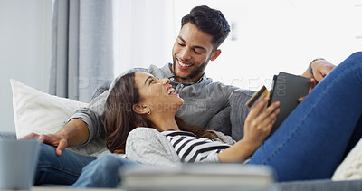 Buy stock photo Funny, credit card and couple on sofa, tablet and relax with ecommerce, investment growth and payment. Laughing, man and woman on couch, online banking and fintech with mortgage, house and savings