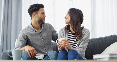 Buy stock photo Happy, talking and couple with coffee on sofa for conversation, bonding and relax together in home. Morning, dating and man with woman with drink for relationship, affection and chill in living room