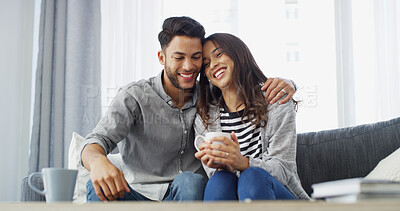 Buy stock photo Happy, hug and couple with coffee on sofa for conversation, bonding and relax together. Home, dating and man with woman with drink for relationship, affection and embrace for love in living room