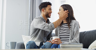 Buy stock photo Happy, relax and couple with coffee, home and chilling in living room with woman, embrace or love. Bonding, man and romance with partner in lounge, tea and comfortable in house, smile or relationship