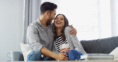 Buy stock photo Home, laugh and couple with coffee on sofa for conversation, bonding and relax together. Happy, dating and man hug woman with drink for relationship, affection and embrace for love in living room